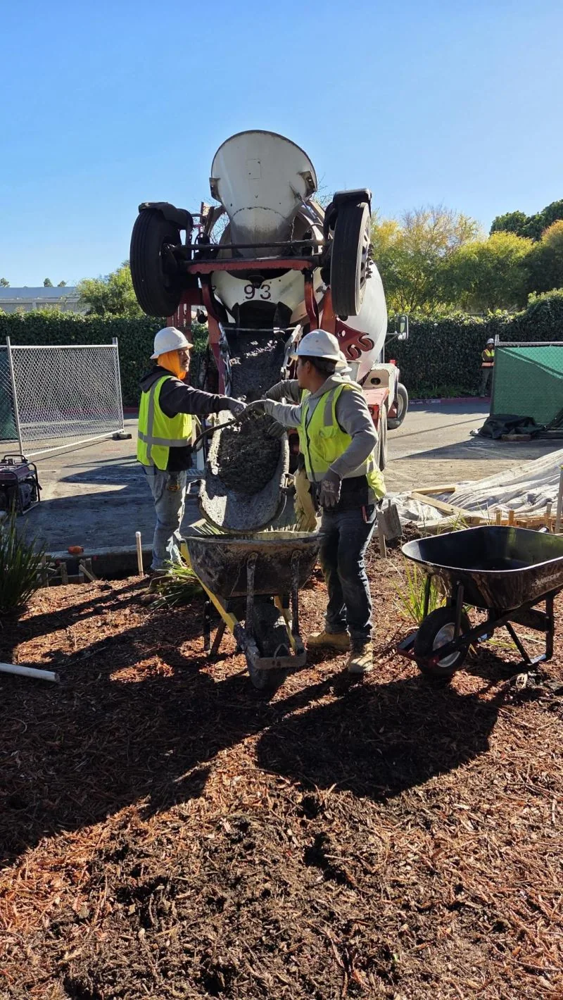 Construction crew pouring concrete at a UCN project site